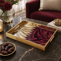 Qatar Flag Silk Glass Serving Tray – Maroon Filigree on a coffee table, featuring UV-printed artwork on tempered glass with an electroplated frame and matching handles.