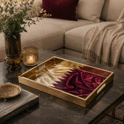 Qatar Flag Silk Glass Serving Tray – Maroon Filigree styled on a console table with a ceramic mug and books beside a brass lamp.