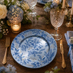 Blue and white toile floral pattern of hibiscus and berries on a round blue decorative charger plate with gold scroll rim for garden party table decor.

Plate type: electroplated (blue)
