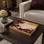 Qatar Flag Wind Glass Serving Tray – Falcon Skyline styled on a console table with a ceramic mug and books beside a brass lamp.