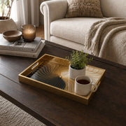 Modern Gold Swirl Abstract Decorative Tray with Black Accents | Minti Home styled on a console table with a ceramic mug and books beside a brass lamp.