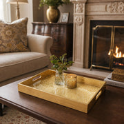 Mandala Glass Serving Tray – Cream Gold Lace Pattern styled on a console table with a ceramic mug and books beside a brass lamp.