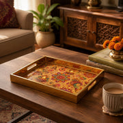 Diwali Paisley Mandala Tray with Diyas - Gold Frame - Minti Home styled on a console table with a ceramic mug and books beside a brass lamp.