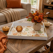 White tray with gold trim featuring watercolor pumpkin and autumn botanical pattern on soft plaid ground