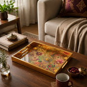 Diwali Floral Paisley Tray with Lotus & Diyas - Gold Frame - Minti Home styled on a console table with a ceramic mug and books beside a brass lamp.