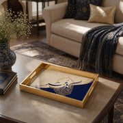 Islamic Glass Serving Tray – Blue Mandala & Arabic Calligraphy styled on a console table with a ceramic mug and books beside a brass lamp.