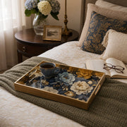 Navy Blue Peony Floral Glass Serving Tray with Gold Frame, 40x30cm styled on a console table with a ceramic mug and books beside a brass lamp.