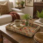 Gold Paisley Plastic Serving Tray – Vintage Floral Border styled on a coffee table with books, a candle, and decorative accessories.