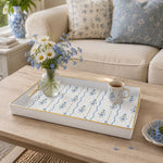 White tray with gold trim featuring blue ribbon bows and forget-me-not flowers