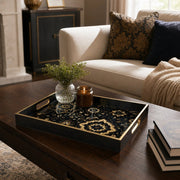 Islamic Geometric Serving Tray with Black Frame and Gold Medallions | Minti Home styled on a console table with a ceramic mug and books beside a brass lamp.