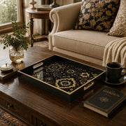 Islamic Geometric Serving Tray with Black Frame and Gold Medallions | Minti Home displayed on a dining table with a porcelain teapot and fresh flowers, vintage cabinet in background.
