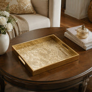 Vintage Gold Damask Arabesque Glass Serving Tray, 40x30cm displayed on a dining table with a porcelain teapot and fresh flowers, vintage cabinet in background.