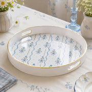 White tray with gold trim featuring blue ribbon bows and forget-me-not flowers
