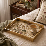 Islamic Mosque Embroidery Gold Decorative Tray with Green Domes and Gold Frame | Minti Home displayed on a dining table with a porcelain teapot and fresh flowers, vintage cabinet in background.