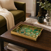 Emerald Malachite Gold Scrollwork Decorative Tray with Ornate Filigree Corners and Gold Frame | Minti Home displayed on a dining table with a porcelain teapot and fresh flowers, vintage cabinet in background.