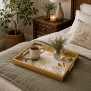 Sage Botanical Cream Gold Decorative Tray with Abstract Leaves and Gold Frame | Minti Home displayed on a dining table with a porcelain teapot and fresh flowers, vintage cabinet in background.